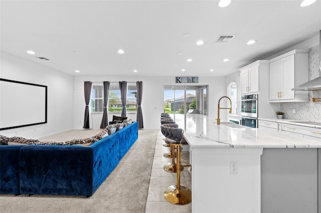 33255 Kateland Dr, Wesley Chapel, FL 33545 - kitchen with open floor plan, recessed lighting, stainless steel double oven, a sink, and white cabinets