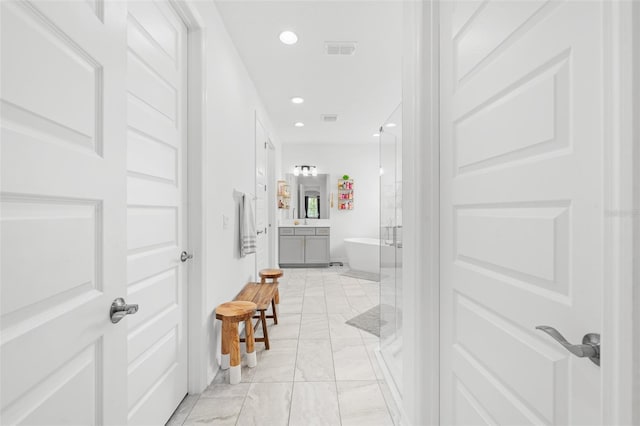 33255 Kateland Dr, Wesley Chapel, FL 33545 - corridor featuring light marble finish flooring, recessed lighting, and baseboards