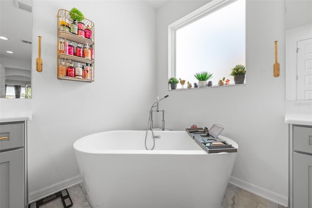33255 Kateland Dr, Wesley Chapel, FL 33545 - bathroom featuring vanity, baseboards, a freestanding tub, and recessed lighting