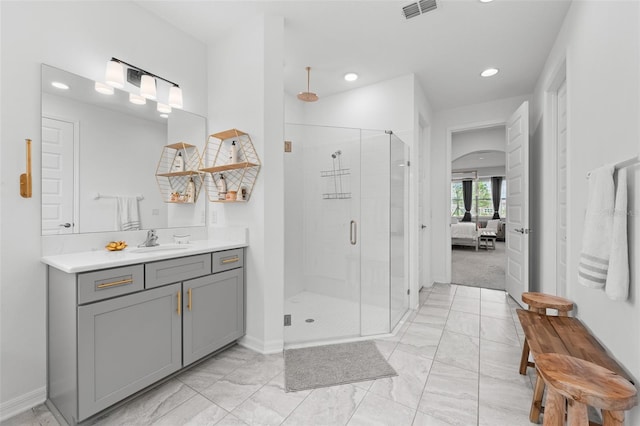 33255 Kateland Dr, Wesley Chapel, FL 33545 - ensuite bathroom featuring marble look tile flooring, a shower stall, vanity, baseboards, and recessed lighting