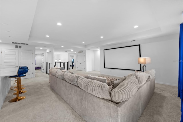 33255 Kateland Dr, Wesley Chapel, FL 33545 - home theater room featuring a tray ceiling, light carpet, recessed lighting, and baseboards