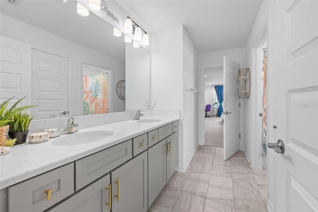 33255 Kateland Dr, Wesley Chapel, FL 33545 - full bathroom featuring marble look tile flooring, double vanity, and baseboards