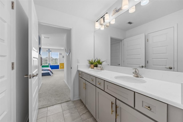 33255 Kateland Dr, Wesley Chapel, FL 33545 - ensuite bathroom with double vanity and baseboards