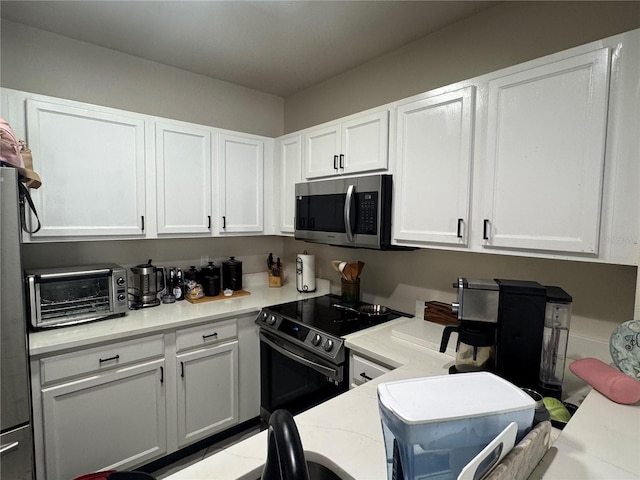 527 Glenn Cross Dr, Ruskin, FL 33570 - kitchen featuring stainless steel appliances and white cabinets