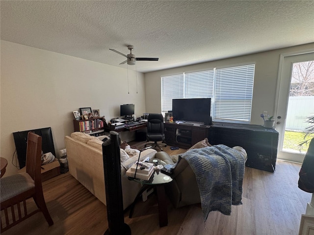 527 Glenn Cross Dr, Ruskin, FL 33570 - living area featuring wood finished floors, a desk, a textured ceiling, and a ceiling fan