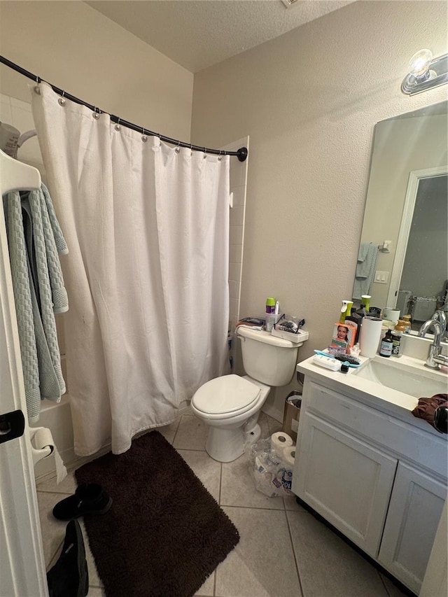 527 Glenn Cross Dr, Ruskin, FL 33570 - bathroom with vanity, toilet, tile patterned floors, and a textured ceiling
