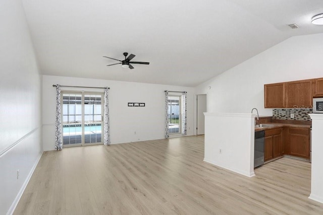 1017 Cameo Crest Ln, Valrico, FL 33596 - unfurnished living room featuring lofted ceiling, a ceiling fan, a sink, light wood finished floors, and healthy amount of natural light