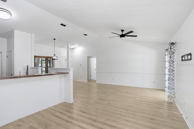 1017 Cameo Crest Ln, Valrico, FL 33596 - unfurnished living room featuring lofted ceiling, a ceiling fan, light wood-type flooring, and baseboards