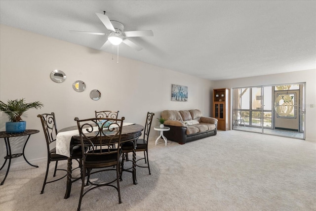 11485 Oakhurst Rd Unit 200-101, Largo, FL 33774 - dining area featuring light colored carpet, baseboards, and a ceiling fan