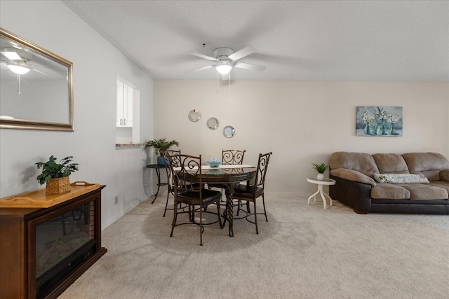 11485 Oakhurst Rd Unit 200-101, Largo, FL 33774 - dining space featuring a ceiling fan, carpet flooring, baseboards, and a textured ceiling
