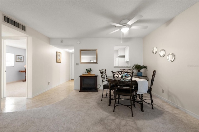 11485 Oakhurst Rd Unit 200-101, Largo, FL 33774 - tiled dining space with carpet, ceiling fan, a textured ceiling, and baseboards