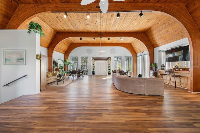11485 Oakhurst Rd Unit 200-101, Largo, FL 33774 - living room with a ceiling fan, rail lighting, wood ceiling, arched walkways, and high vaulted ceiling