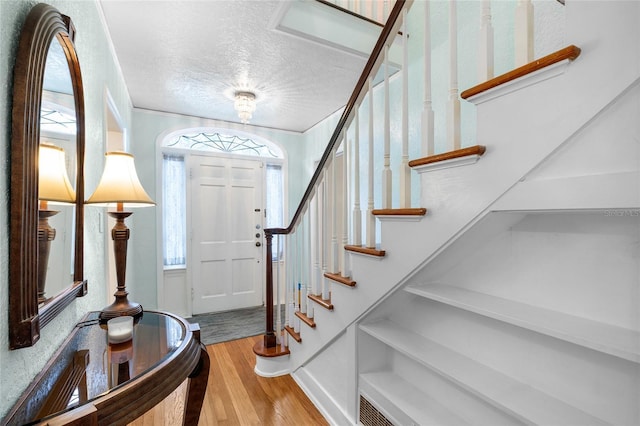 1226 SE 9th Ave, Ocala, FL 34471 - entrance foyer with wood finished floors, stairway, and a textured ceiling