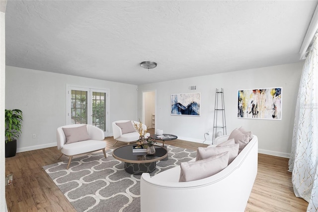 1226 SE 9th Ave, Ocala, FL 34471 - living area featuring wood finished floors, a textured ceiling, and baseboards