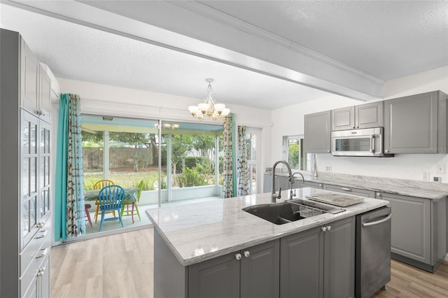 1226 SE 9th Ave, Ocala, FL 34471 - kitchen featuring gray cabinetry, a sink, appliances with stainless steel finishes, a chandelier, and a textured ceiling