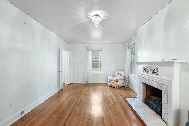 1226 SE 9th Ave, Ocala, FL 34471 - living room featuring hardwood / wood-style floors, a high end fireplace, and baseboards