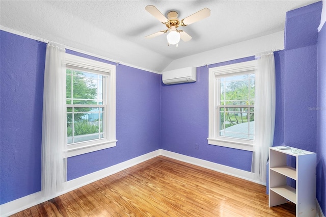 1226 SE 9th Ave, Ocala, FL 34471 - unfurnished room with a wall mounted air conditioner, plenty of natural light, baseboards, vaulted ceiling, and wood finished floors