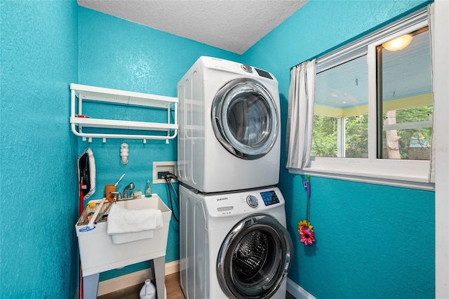 1226 SE 9th Ave, Ocala, FL 34471 - laundry room featuring stacked washer and clothes dryer, a textured wall, a textured ceiling, and baseboards