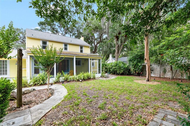 1226 SE 9th Ave, Ocala, FL 34471 - back of house with a sunroom and a chimney