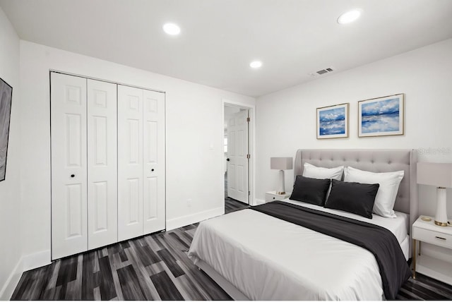 1119 Eau Claire Cir, Tampa, FL 33619 - bedroom featuring dark wood-style flooring, recessed lighting, a closet, and baseboards