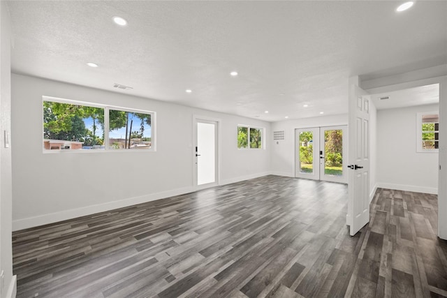 1119 Eau Claire Cir, Tampa, FL 33619 - unfurnished living room with recessed lighting, healthy amount of natural light, french doors, dark wood-type flooring, and baseboards
