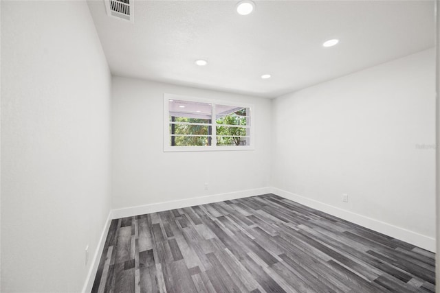 1119 Eau Claire Cir, Tampa, FL 33619 - spare room featuring dark wood-style floors, baseboards, and recessed lighting
