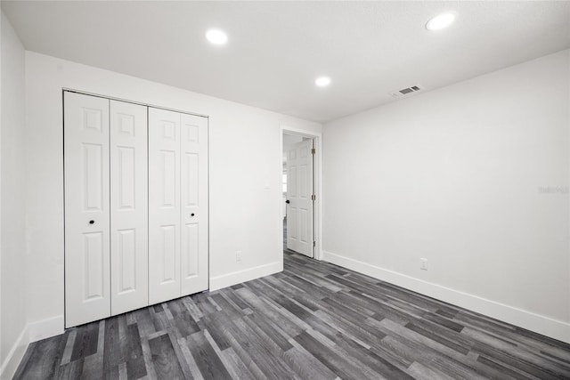 1119 Eau Claire Cir, Tampa, FL 33619 - unfurnished bedroom with recessed lighting, dark wood-style flooring, baseboards, and a closet