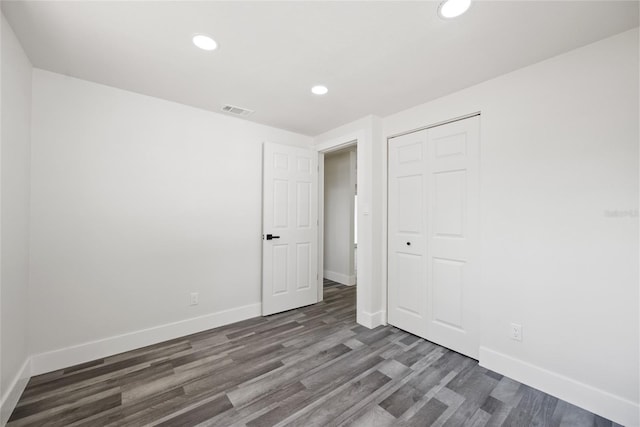 1119 Eau Claire Cir, Tampa, FL 33619 - unfurnished bedroom with wood finished floors, baseboards, recessed lighting, and a closet