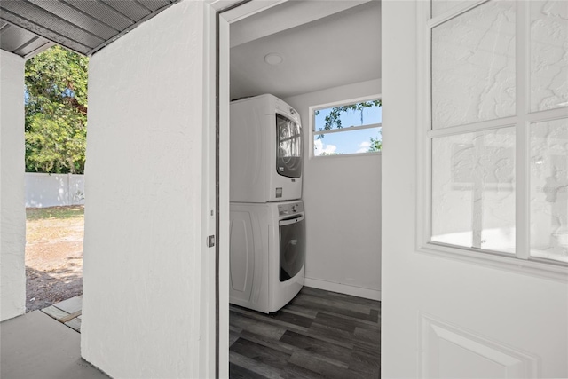 1119 Eau Claire Cir, Tampa, FL 33619 - laundry room with stacked washing machine and dryer, dark wood-style floors, and baseboards