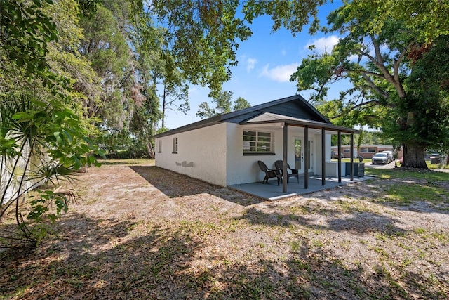 1119 Eau Claire Cir, Tampa, FL 33619 - rear view of property with stucco siding