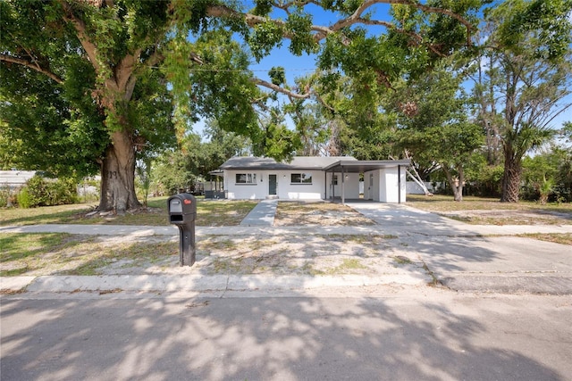 1119 Eau Claire Cir, Tampa, FL 33619 - view of front facade featuring a carport and concrete driveway