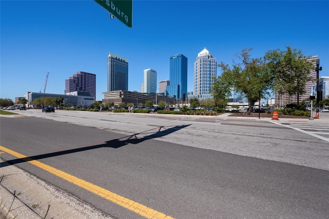 1119 Eau Claire Cir, Tampa, FL 33619 - view of asphalt road featuring a view of skyline and sidewalks