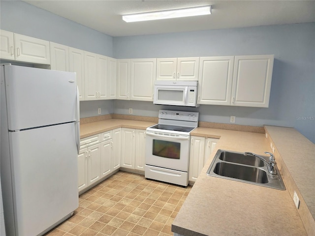 5303 Terraza Ct, Temple Terrace, FL 33617 - kitchen featuring white appliances, white cabinets, and light countertops