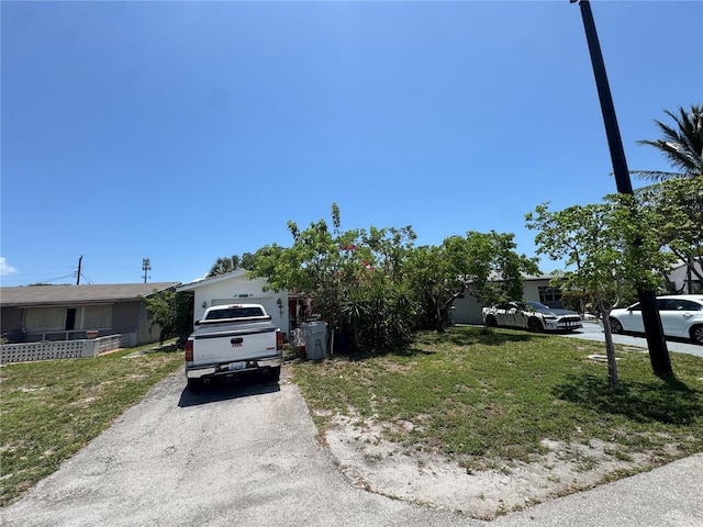 3730 NE 17th Ave, Pompano Beach, FL 33064 - view of property hidden behind natural elements with a front lawn and driveway