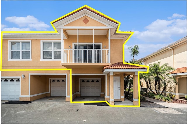 21007 Sunpoint Way Unit 203, Lutz, FL 33558 - view of property with stucco siding and a garage