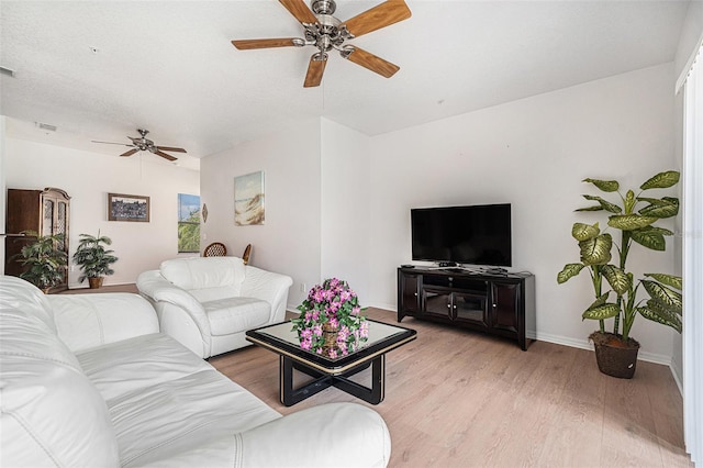 21007 Sunpoint Way Unit 203, Lutz, FL 33558 - living room featuring a ceiling fan, light wood finished floors, and baseboards