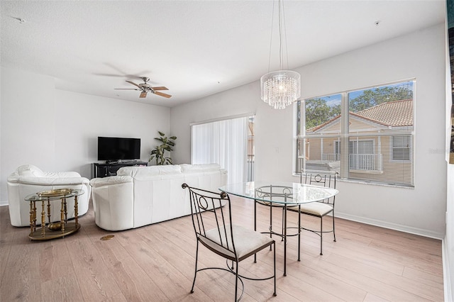 21007 Sunpoint Way Unit 203, Lutz, FL 33558 - dining space with light wood finished floors, a chandelier, ceiling fan, and baseboards