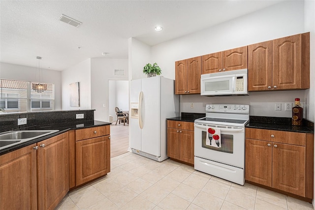 21007 Sunpoint Way Unit 203, Lutz, FL 33558 - kitchen with white appliances, brown cabinetry, and recessed lighting