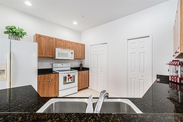21007 Sunpoint Way Unit 203, Lutz, FL 33558 - kitchen with white appliances, a sink, brown cabinets, recessed lighting, and light tile patterned floors
