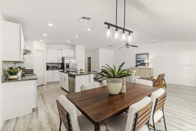 8812 Parsons Hill Blvd, Wesley Chapel, FL 33545 - dining room featuring light wood finished floors, vaulted ceiling, recessed lighting, and ceiling fan