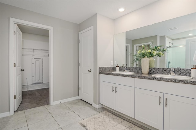 8812 Parsons Hill Blvd, Wesley Chapel, FL 33545 - bathroom with double vanity, a shower stall, baseboards, a walk in closet, and recessed lighting