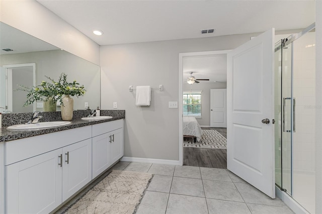 8812 Parsons Hill Blvd, Wesley Chapel, FL 33545 - full bath featuring double vanity, a stall shower, a ceiling fan, tile patterned flooring, and baseboards