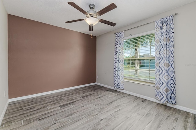 8812 Parsons Hill Blvd, Wesley Chapel, FL 33545 - spare room featuring light wood-style floors, baseboards, and ceiling fan