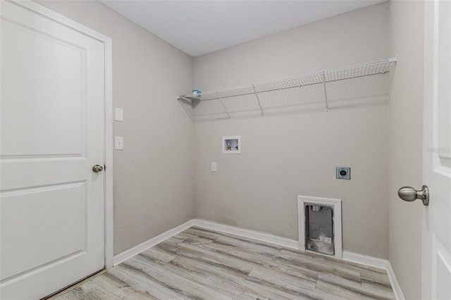8812 Parsons Hill Blvd, Wesley Chapel, FL 33545 - laundry room featuring electric dryer hookup, light wood-type flooring, hookup for a washing machine, and baseboards
