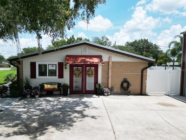 1423 Spruce Rd N, Lakeland, FL 33809 - view of front of house featuring french doors and brick siding
