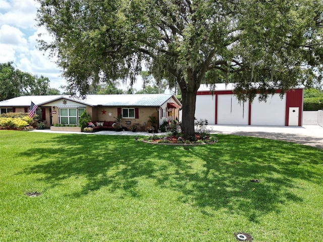 1423 Spruce Rd N, Lakeland, FL 33809 - single story home with a front lawn, a garage, metal roof, and driveway