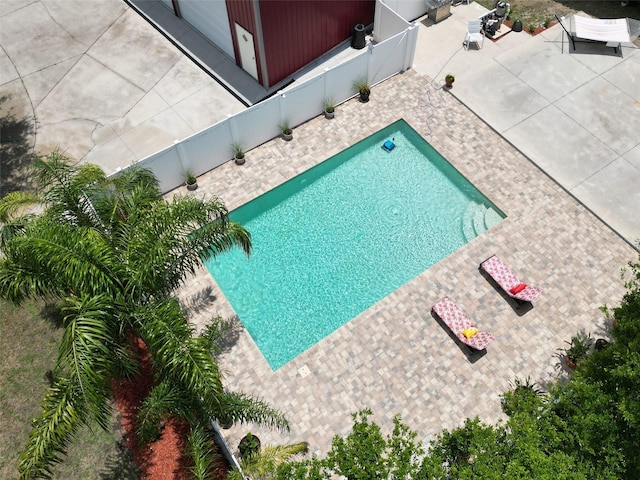 1423 Spruce Rd N, Lakeland, FL 33809 - outdoor pool with a patio area and a fenced backyard