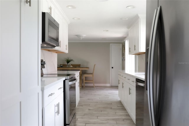 1423 Spruce Rd N, Lakeland, FL 33809 - kitchen with appliances with stainless steel finishes, light countertops, baseboards, white cabinetry, and ornamental molding