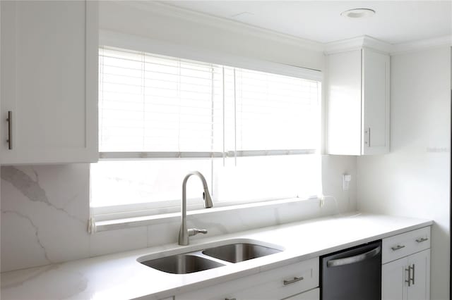 1423 Spruce Rd N, Lakeland, FL 33809 - kitchen with stainless steel dishwasher, a sink, white cabinetry, and ornamental molding