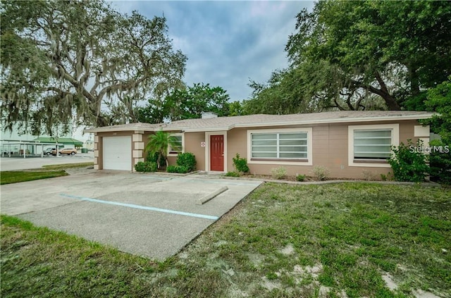 6345 Lambert Ln, New Port Richey, FL 34652 - single story home featuring an attached garage and a front lawn